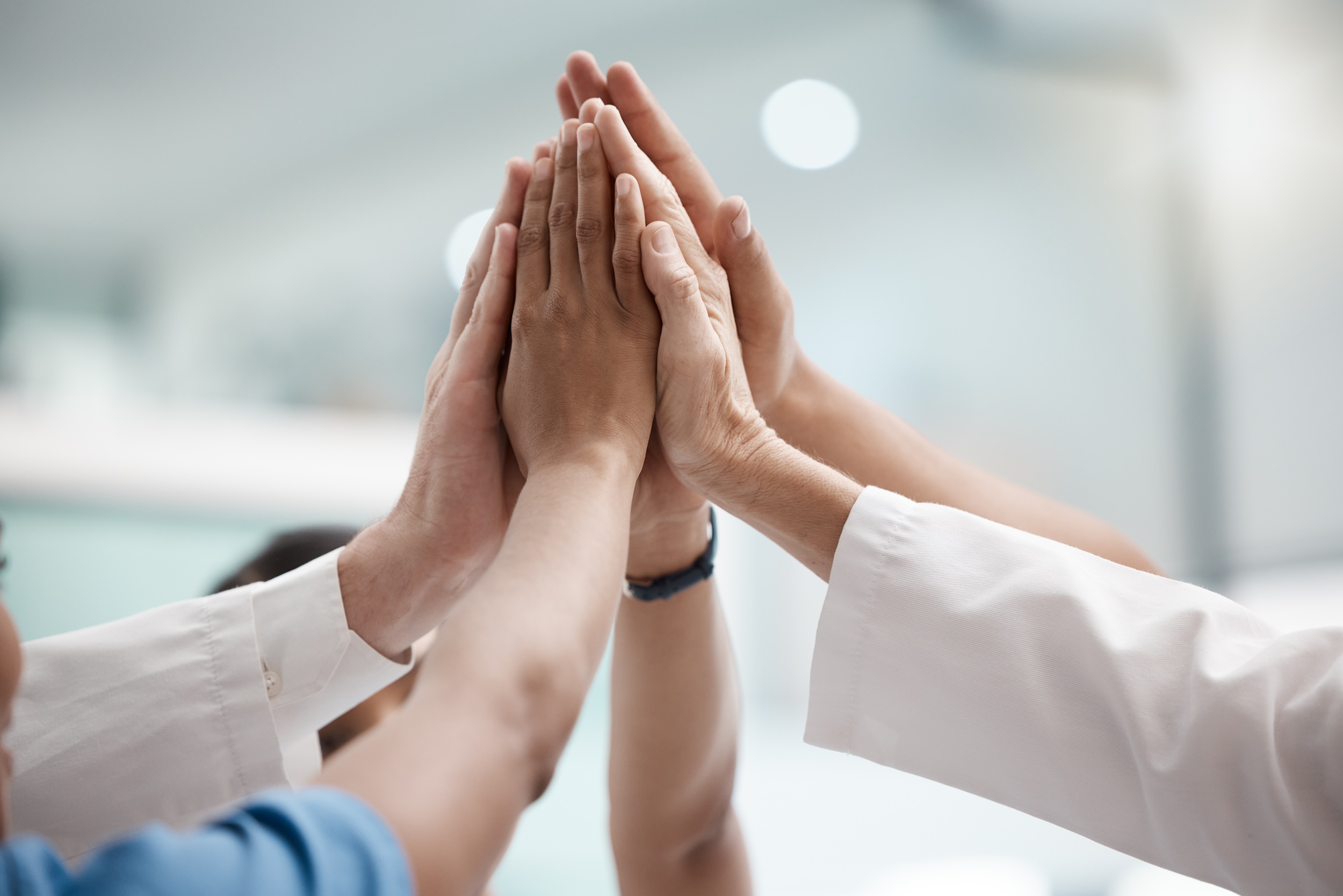 High five, teamwork and doctors hands in collaboration for mission, goal or team building together. Mindset, target or medical group with trust, motivation or support for vision, winning or success.